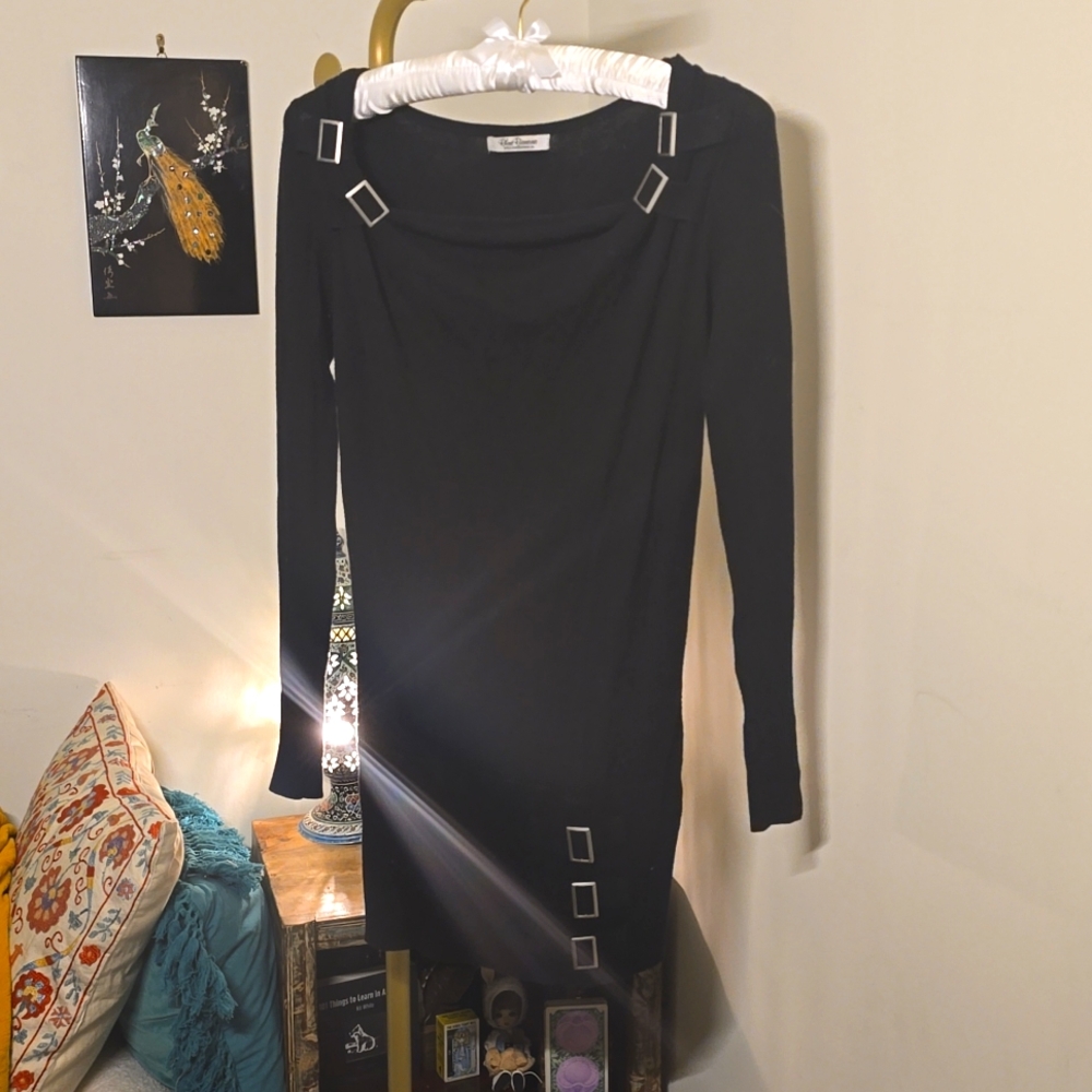 Black off-shoulder sweater dress with square silver buckle detail
